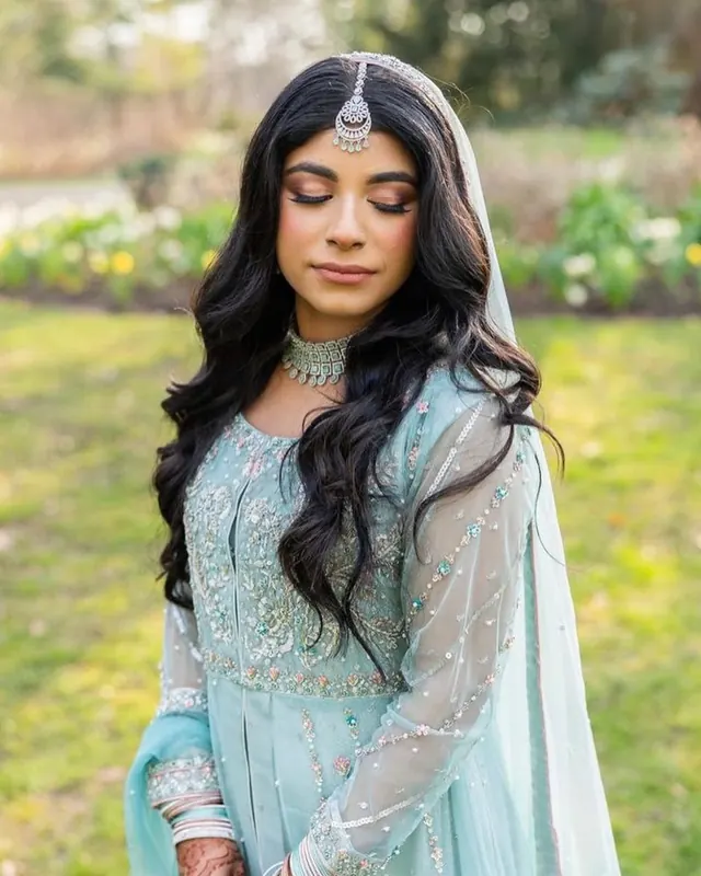 Bride in pastel blue outdoors, makeup by Samia