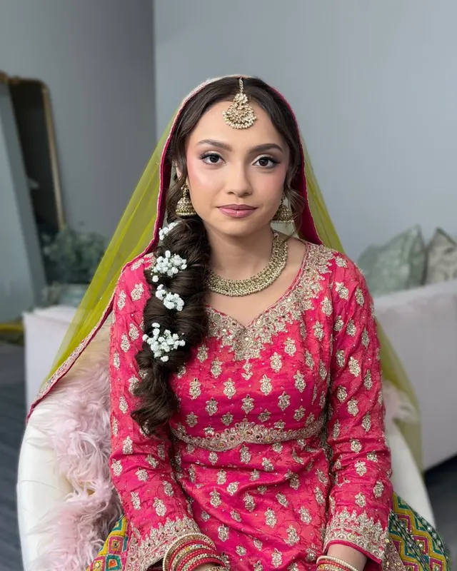Bride in bright pink with a flower braid, makeup by Samia